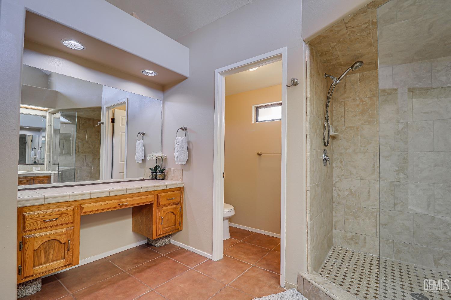 Undisclosed Address Bakersfield, CA 93311 - Photo 33 of 51 a spacious bathroom with a shower and a sink