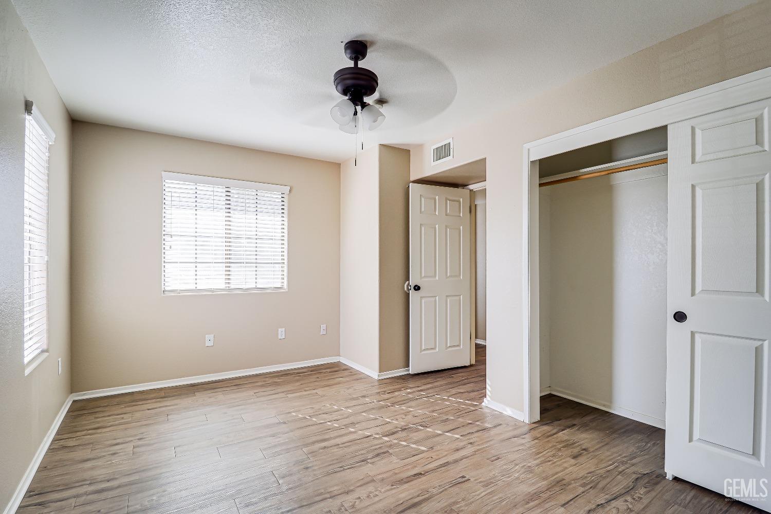 Undisclosed Address Bakersfield, CA 93311 - Photo 35 of 51 a view of an empty room with wooden floor and a window