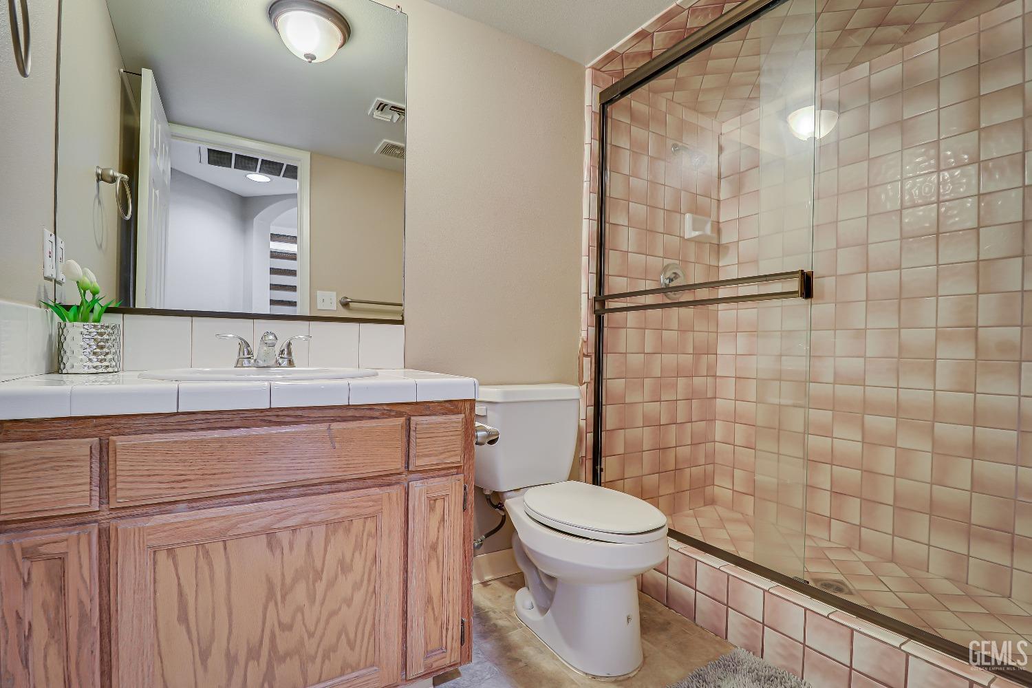 Undisclosed Address Bakersfield, CA 93311 - Photo 38 of 51 a bathroom with a sink a toilet and mirror