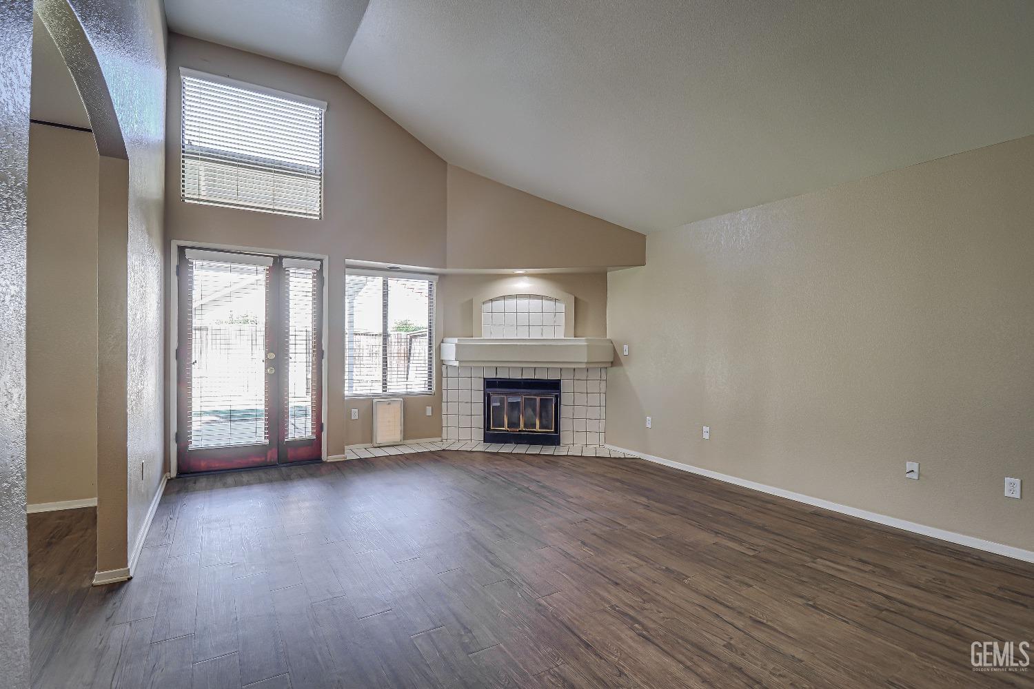 Undisclosed Address Bakersfield, CA 93311 - Photo 6 of 51 wooden floor fireplace and windows in an empty room