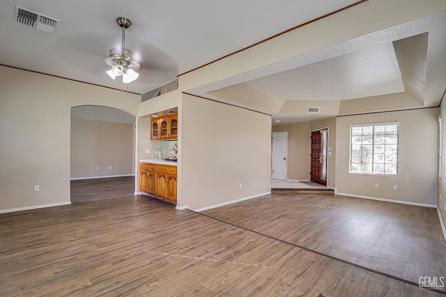 Undisclosed Address Bakersfield, CA 93311 - Photo 10 of 51 a view of an empty room with wooden floor and a window