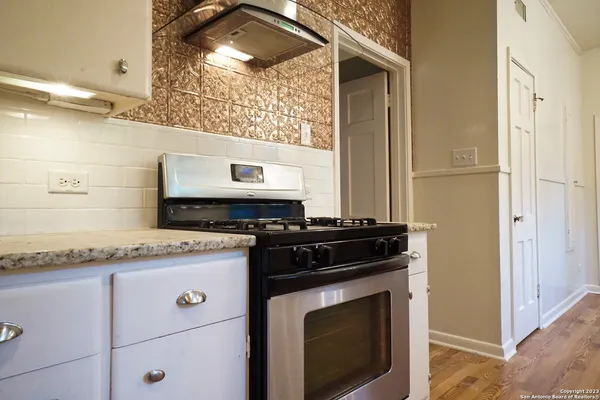 a stove top oven sitting inside of a kitchen