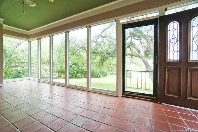 a view of an empty room with a floor to ceiling window and an outdoor view