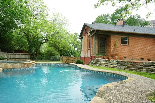 a view of a house with swimming pool and yard