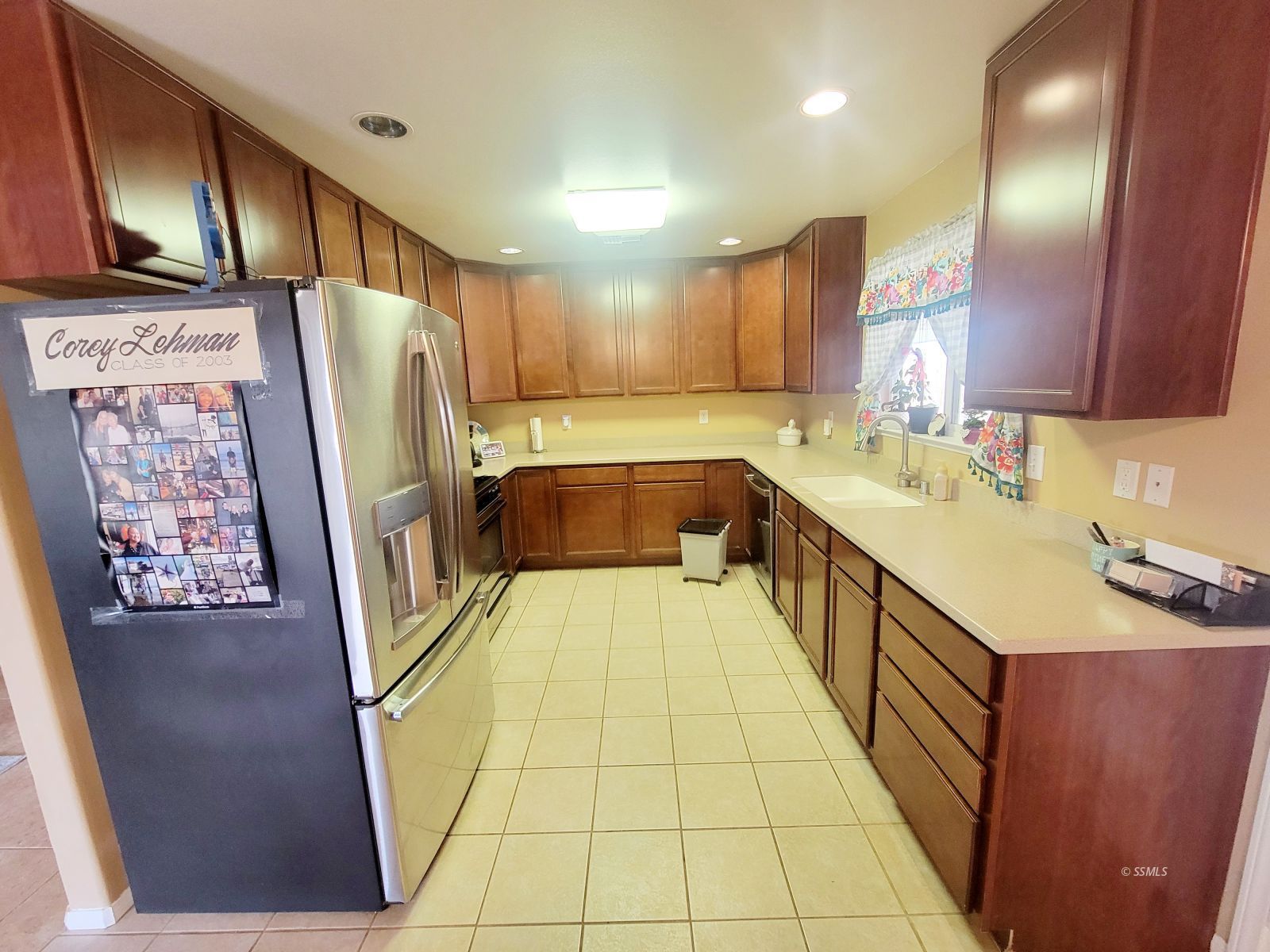 1533 South McCall Street Ridgecrest, CA 93555 - Photo 4 of 13 a kitchen with a sink a refrigerator and cabinets
