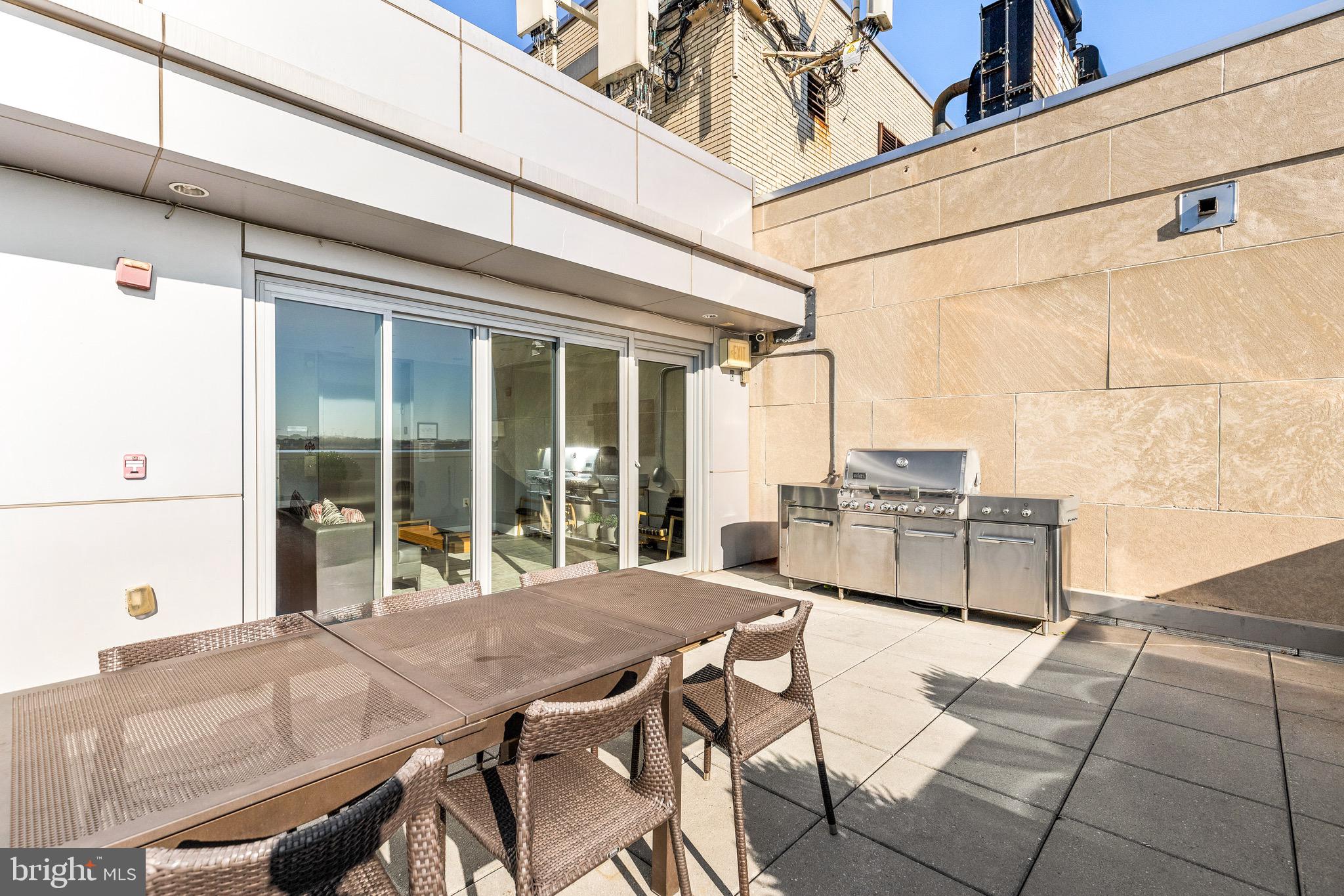 1401 R Street Northwest, Unit 206 Washington, DC 20009 - Photo 17 of 23 a view of a patio with table and chairs and wooden fence