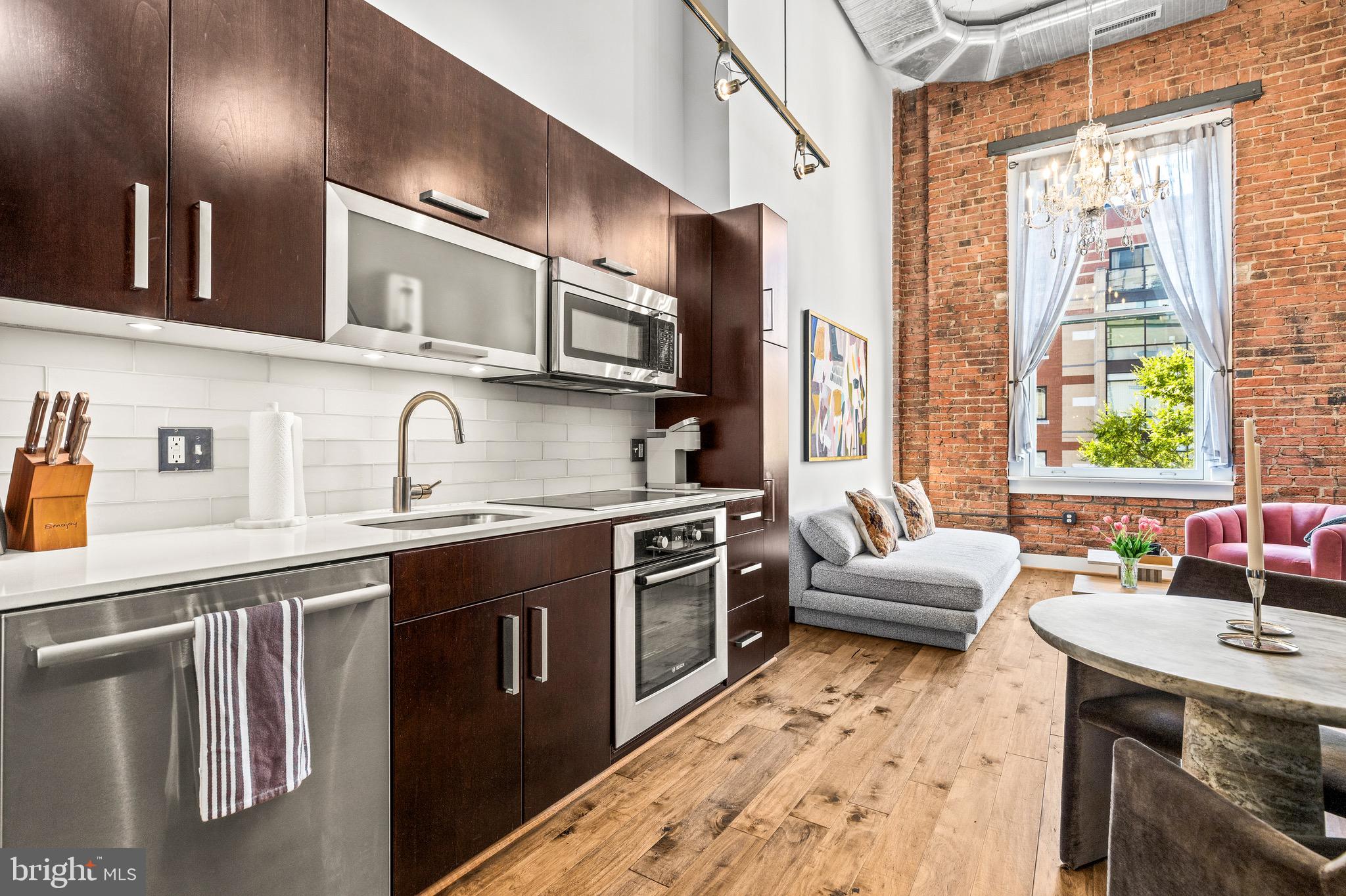 1401 R Street Northwest, Unit 206 Washington, DC 20009 - Photo 6 of 23 a kitchen with stainless steel appliances granite countertop a sink stove and refrigerator
