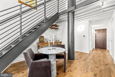 a view of a couches and table in the balcony