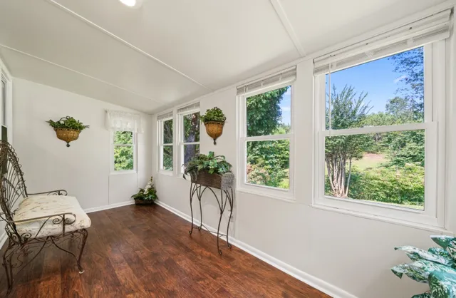 a view of a workspace with furniture and window