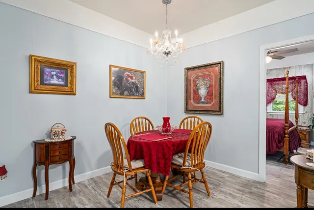 a living room with furniture a flat screen tv and a table