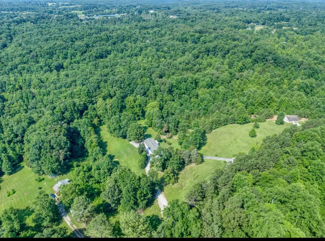 an aerial view of a house with a yard