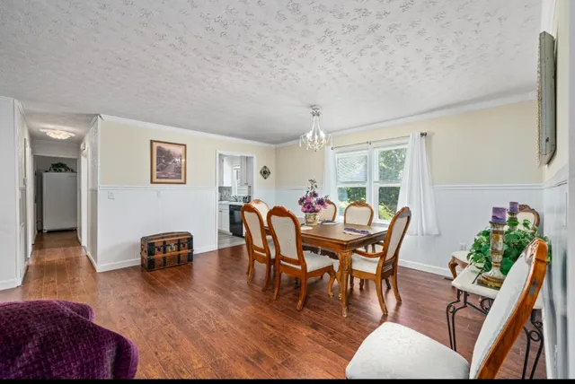 a dining room with furniture and wooden floor