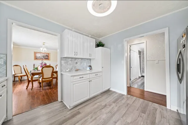 a view of dining table chairs and wooden floor