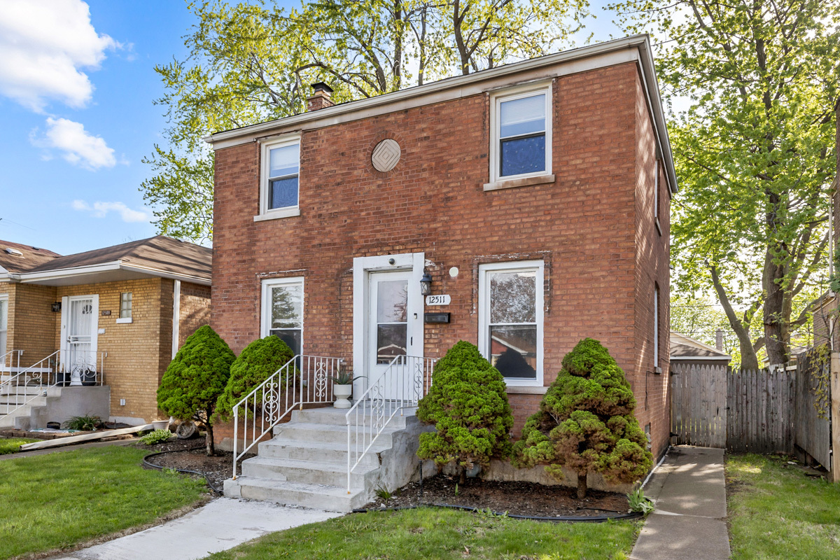 12511 South State Street Chicago, IL 60628 - Photo 1 of 26 a front view of house with yard and green space
