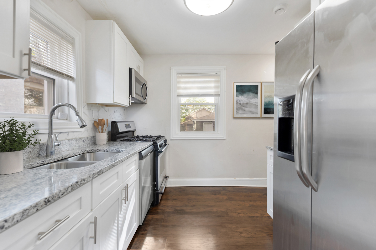 12511 South State Street Chicago, IL 60628 - Photo 12 of 26 a kitchen with stainless steel appliances granite countertop a refrigerator and a sink