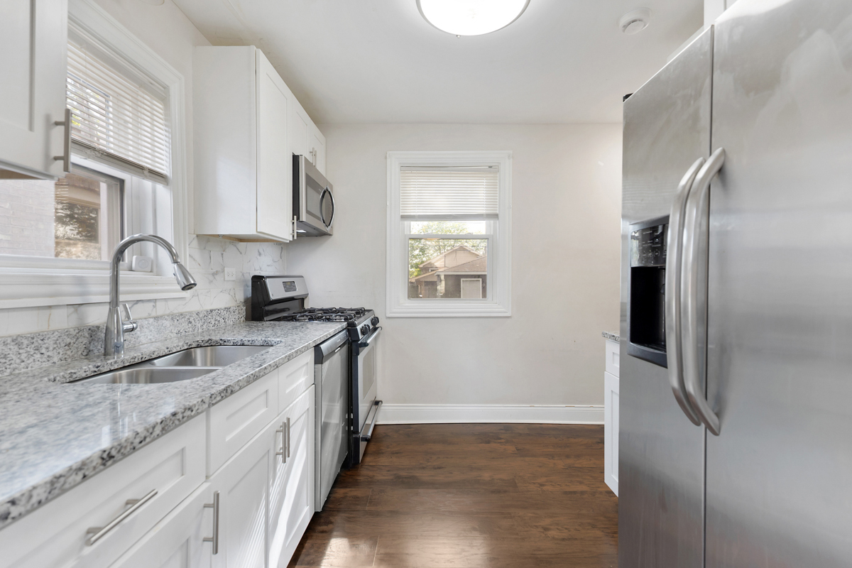12511 South State Street Chicago, IL 60628 - Photo 13 of 26 a kitchen with stainless steel appliances granite countertop a refrigerator and a sink