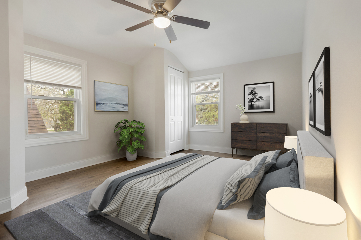12511 South State Street Chicago, IL 60628 - Photo 14 of 26 a bedroom with a bed and a chandelier