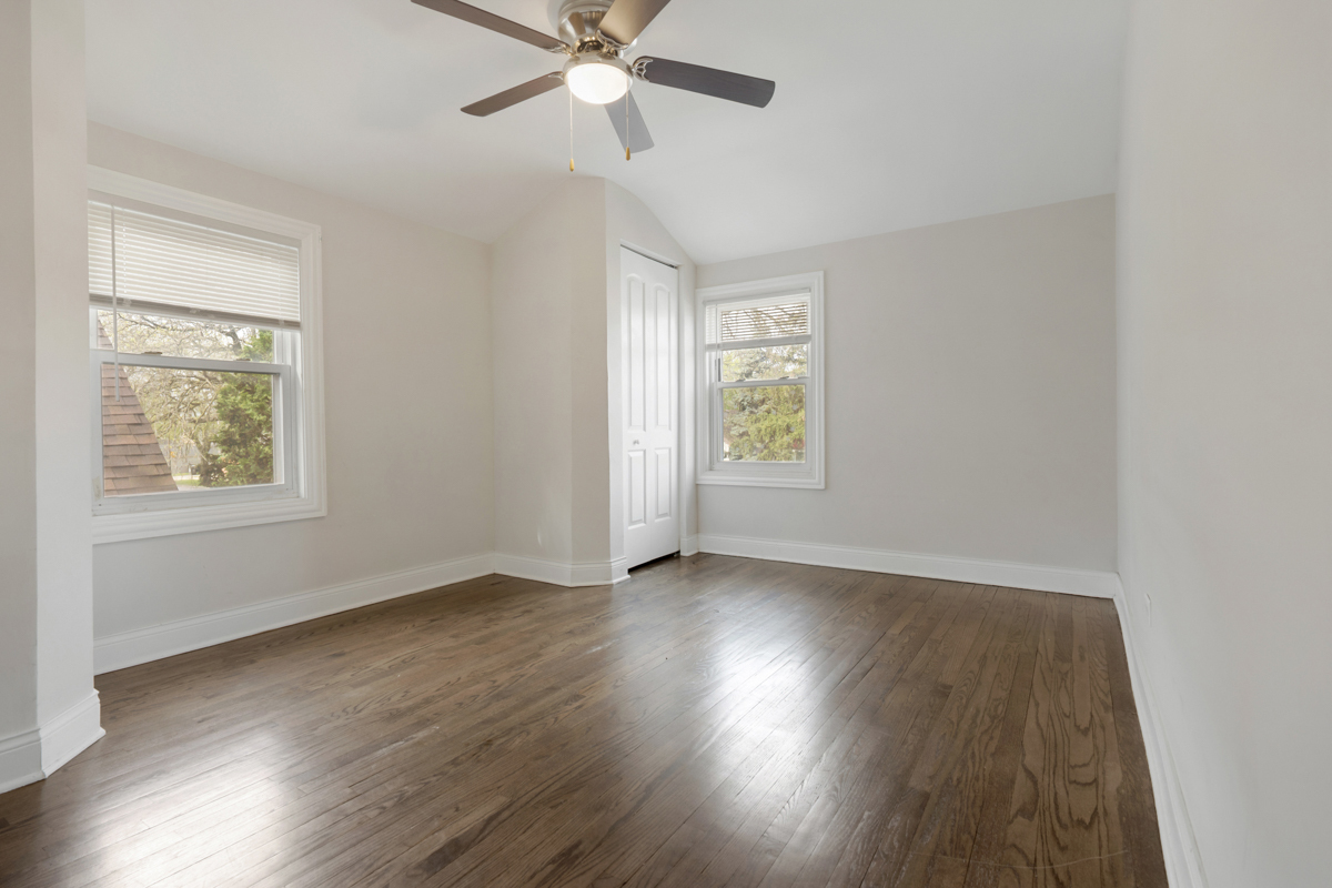 12511 South State Street Chicago, IL 60628 - Photo 15 of 26 a view of an empty room with wooden floor and a window
