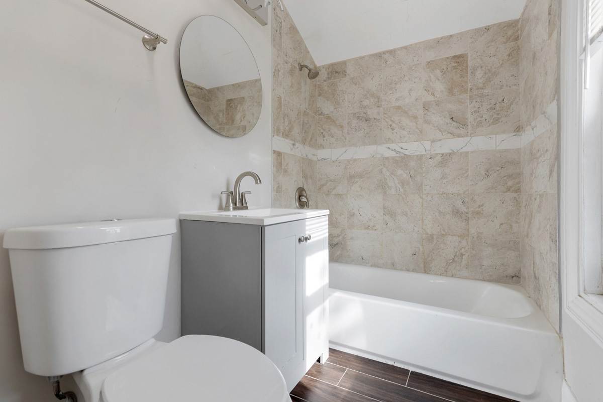 12511 South State Street Chicago, IL 60628 - Photo 16 of 26 a bathroom with a sink a toilet and a bathtub