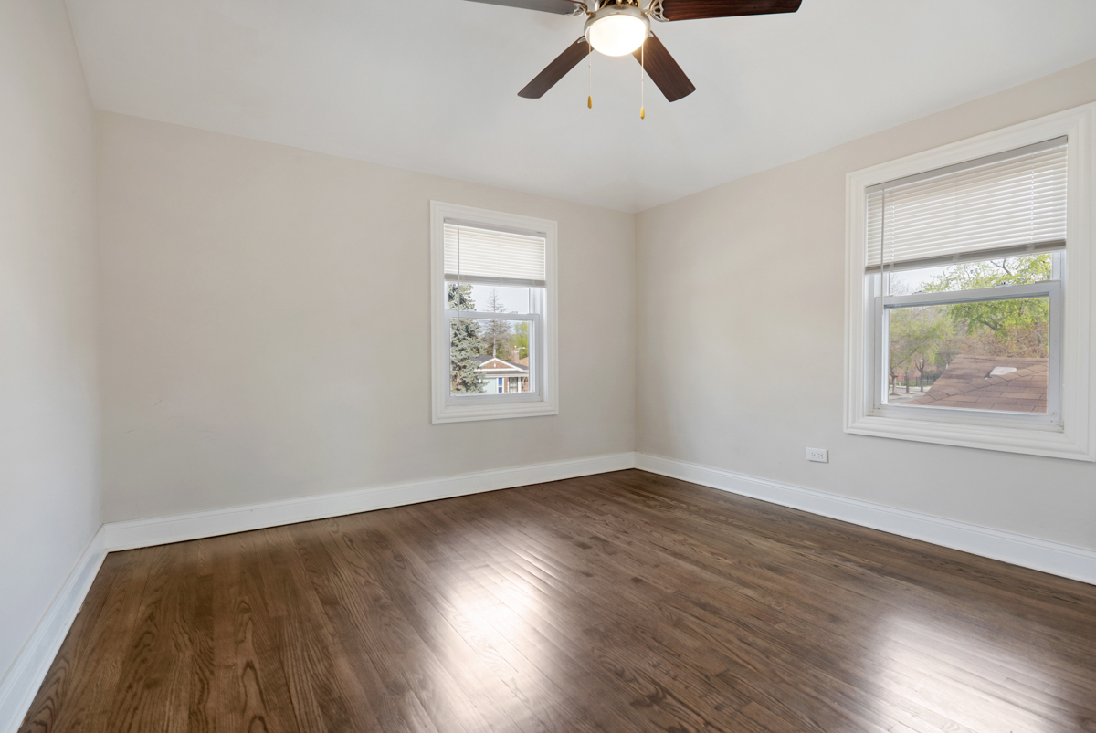 12511 South State Street Chicago, IL 60628 - Photo 17 of 26 a view of an empty room with wooden floor and a window