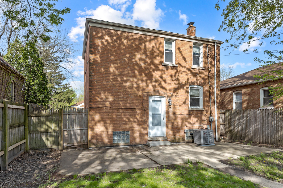 12511 South State Street Chicago, IL 60628 - Photo 23 of 26 a view of a blue house with a yard