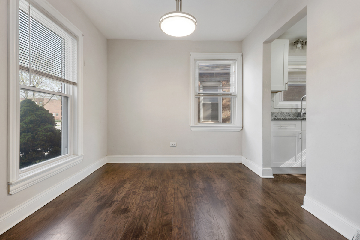12511 South State Street Chicago, IL 60628 - Photo 8 of 26 an empty room with wooden floor and windows