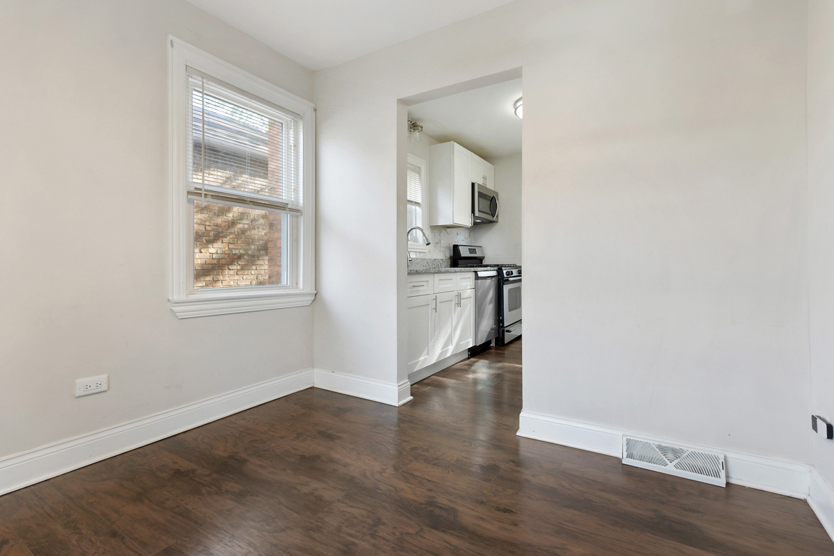 12511 South State Street Chicago, IL 60628 - Photo 9 of 26 an empty room with wooden floor and windows