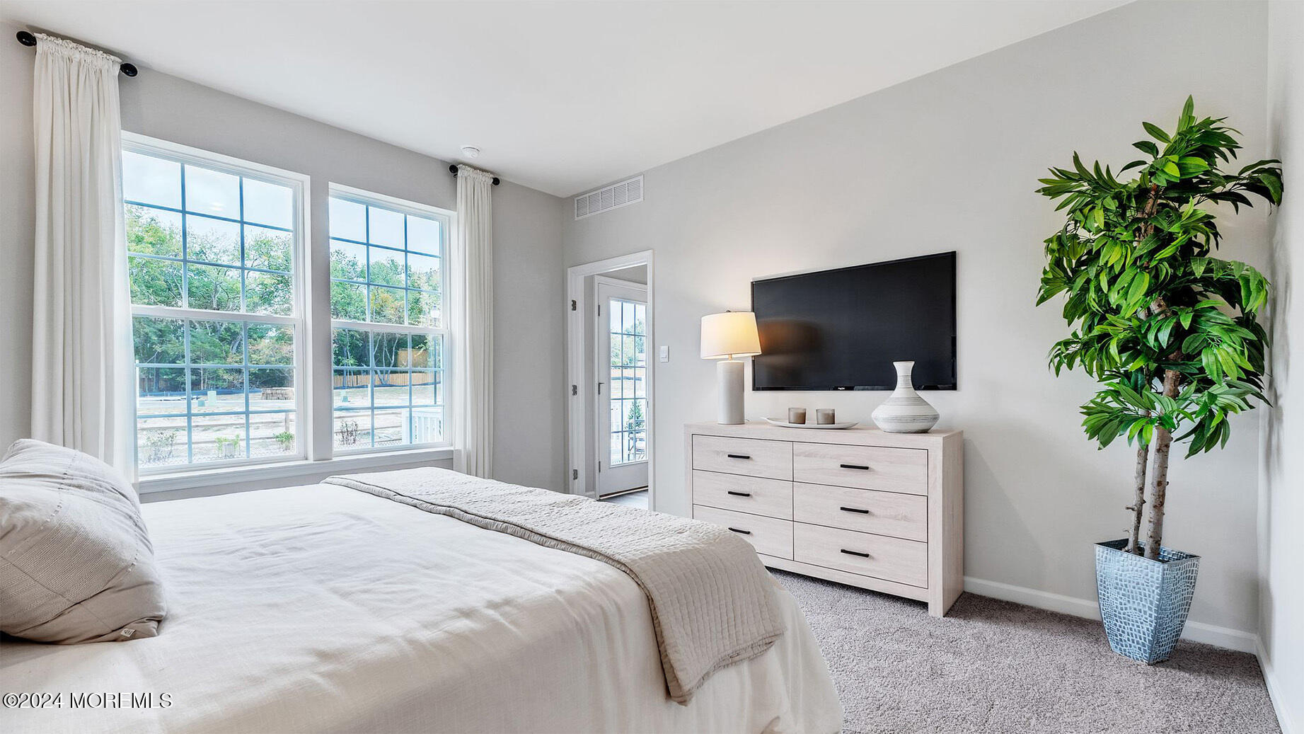 52 Victoria Gdns Square Neptune, NJ 07753 - Photo 18 of 29 a bedroom with a bed and a potted plant