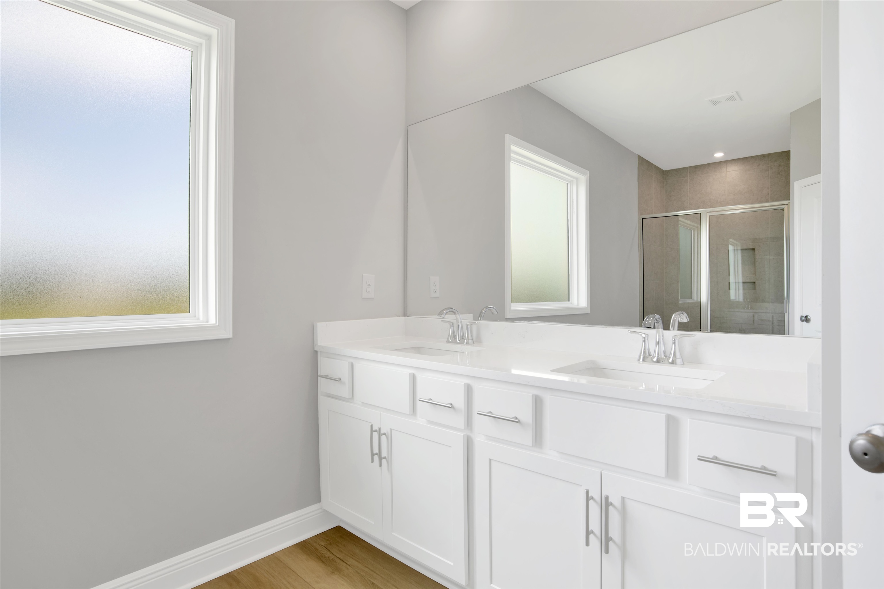 23852 Lafite Circle Daphne, AL 36526 - Photo 19 of 30 Bathroom with a stall shower, double vanity, and wood finished floors