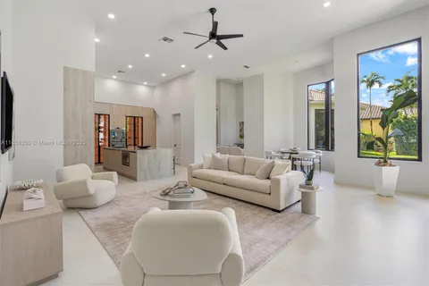 a bedroom with a bed flat screen tv and a large window