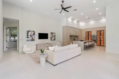 an empty room with a ceiling fan and wooden floor