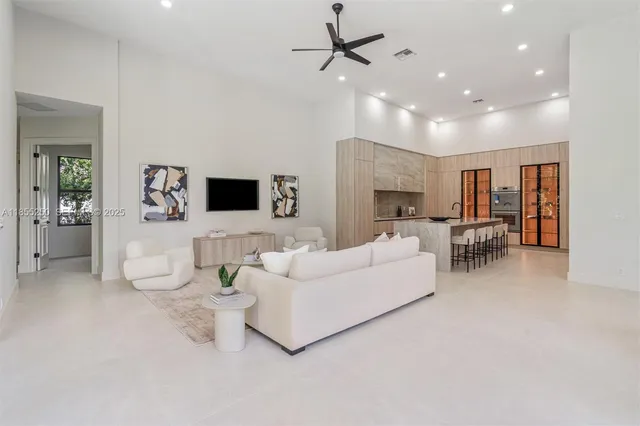 an empty room with a ceiling fan and wooden floor