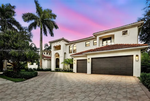 a kitchen with stainless steel appliances granite countertop a sink and a refrigerator
