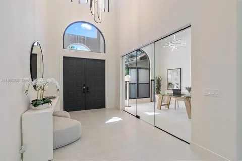a kitchen with kitchen island a sink and a large window