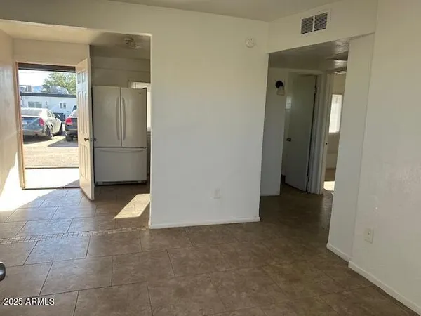 a view of a refrigerator in a kitchen