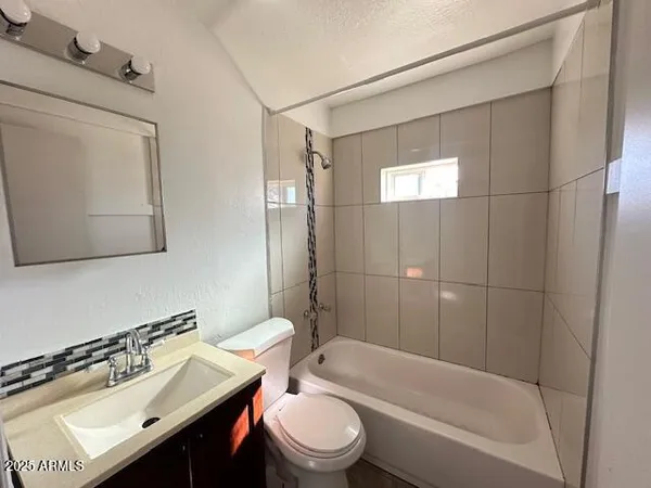 a bathroom with a sink toilet tub and shower