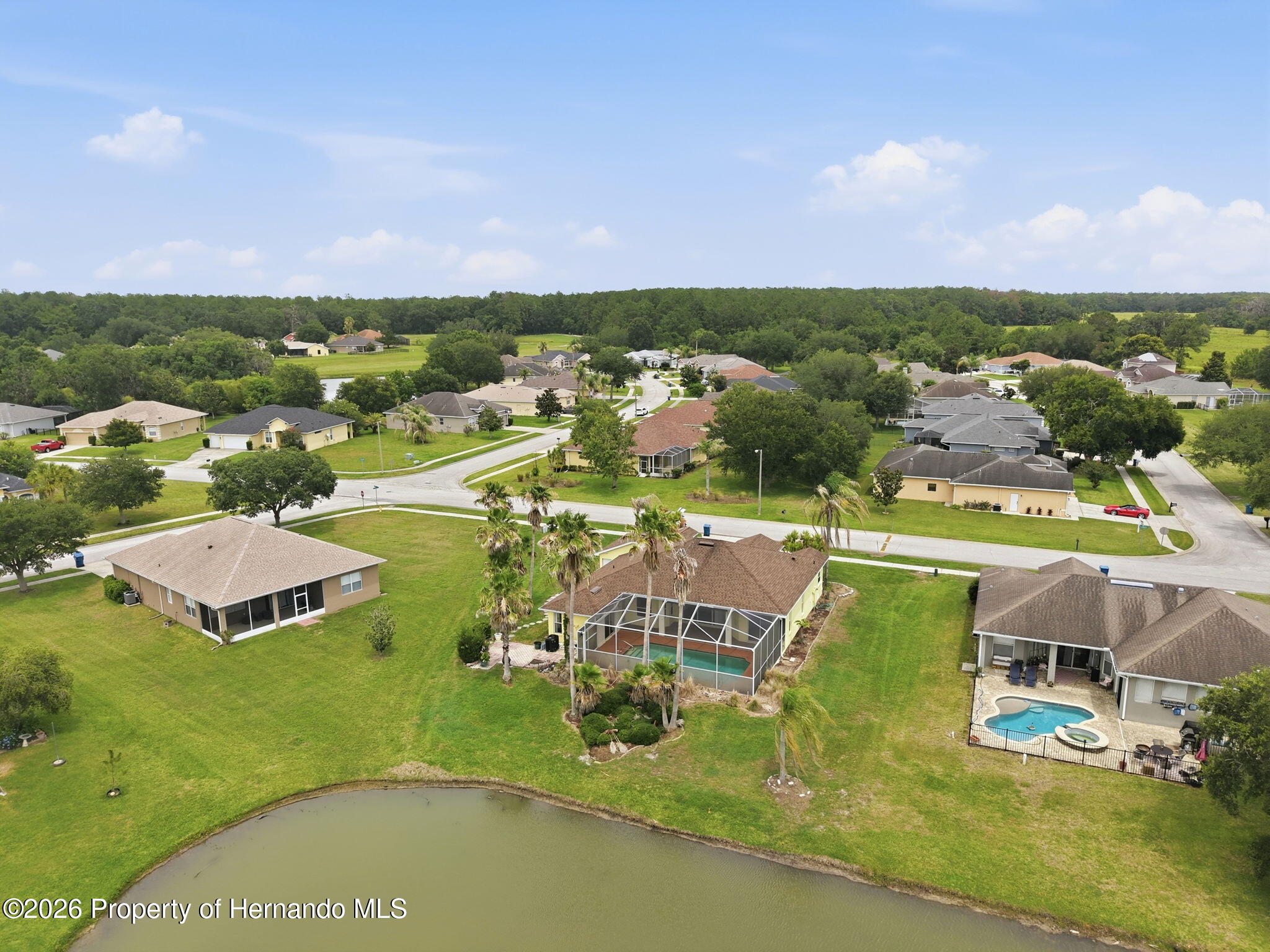 18131 Rivard Boulevard Brooksville, FL 34604 - Photo 57 of 66 an aerial view of a house with a garden