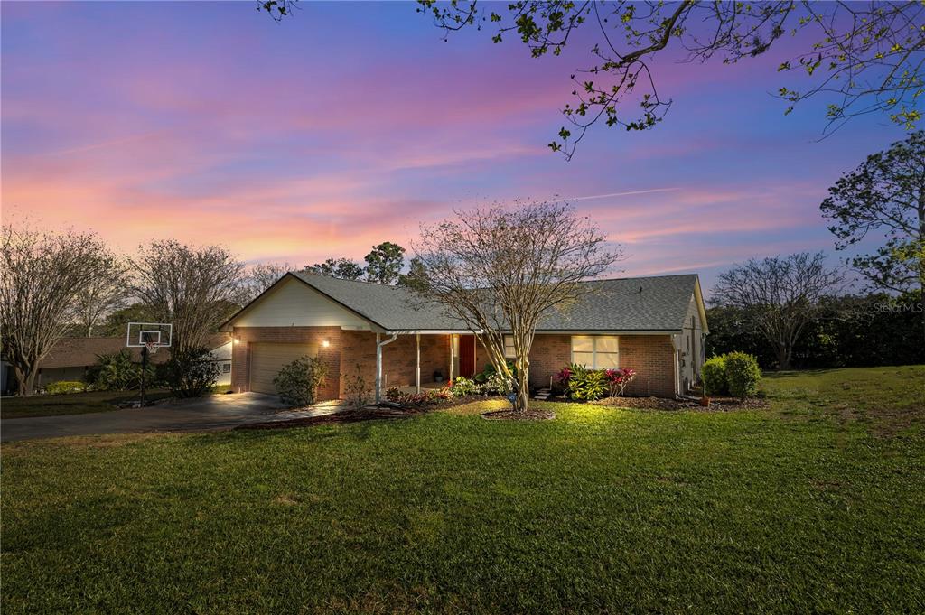12235 Warren Road Clermont, FL 34711 - Photo 1 of 1 a front view of a house with a yard