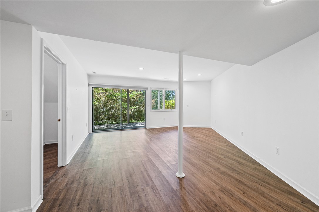 118 Beacon Ridge Circle Salem, SC 29676 - Photo 27 of 45 A spacious lower-level room offers wood-look flooring and ample natural light through large glass doors and windows.
