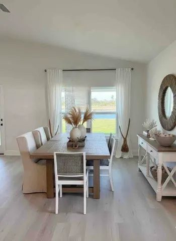 a view of a dining room with furniture and a window