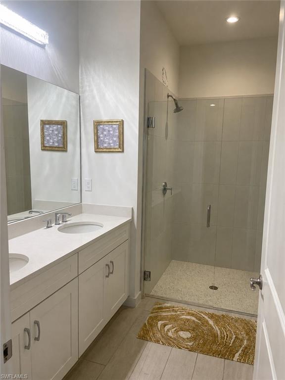 14866 Loggerhead Drive Naples, FL 34120 - Photo 9 of 16 a bathroom with a sink and a mirror
