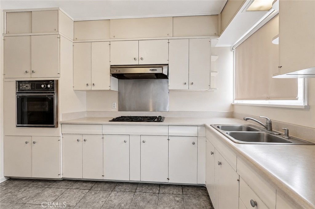2209 Queensberry Road Pasadena, CA 91104 - Photo 16 of 44 a kitchen with white cabinets and sink