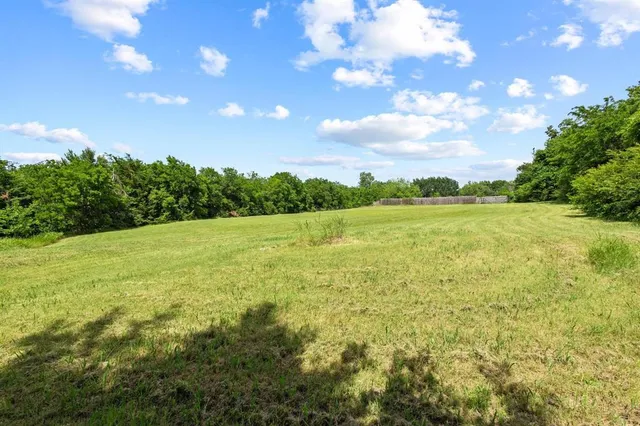 a view of yard with swimming pool and green space