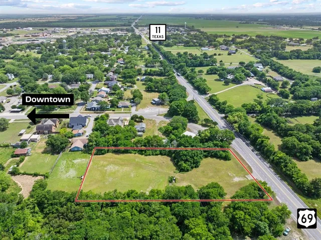 an aerial view of a residential houses with outdoor space and swimming pool