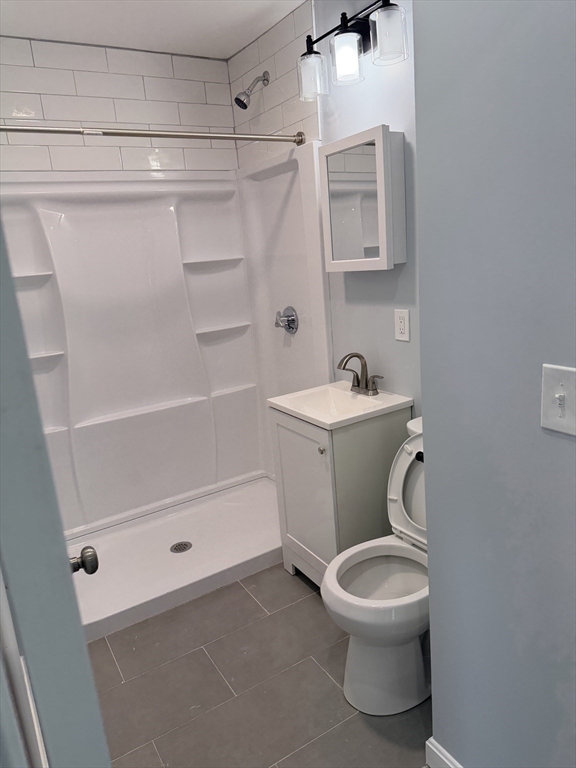 15 Mechanic Street, Unit 2 Attleboro, MA 02703 - Photo 11 of 15 a bathroom with a sink a toilet and shower