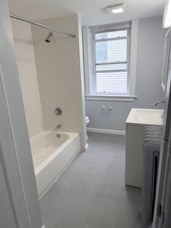 15 Mechanic Street, Unit 2 Attleboro, MA 02703 - Photo 12 of 15 a bathroom with a tub a sink a window and a shower