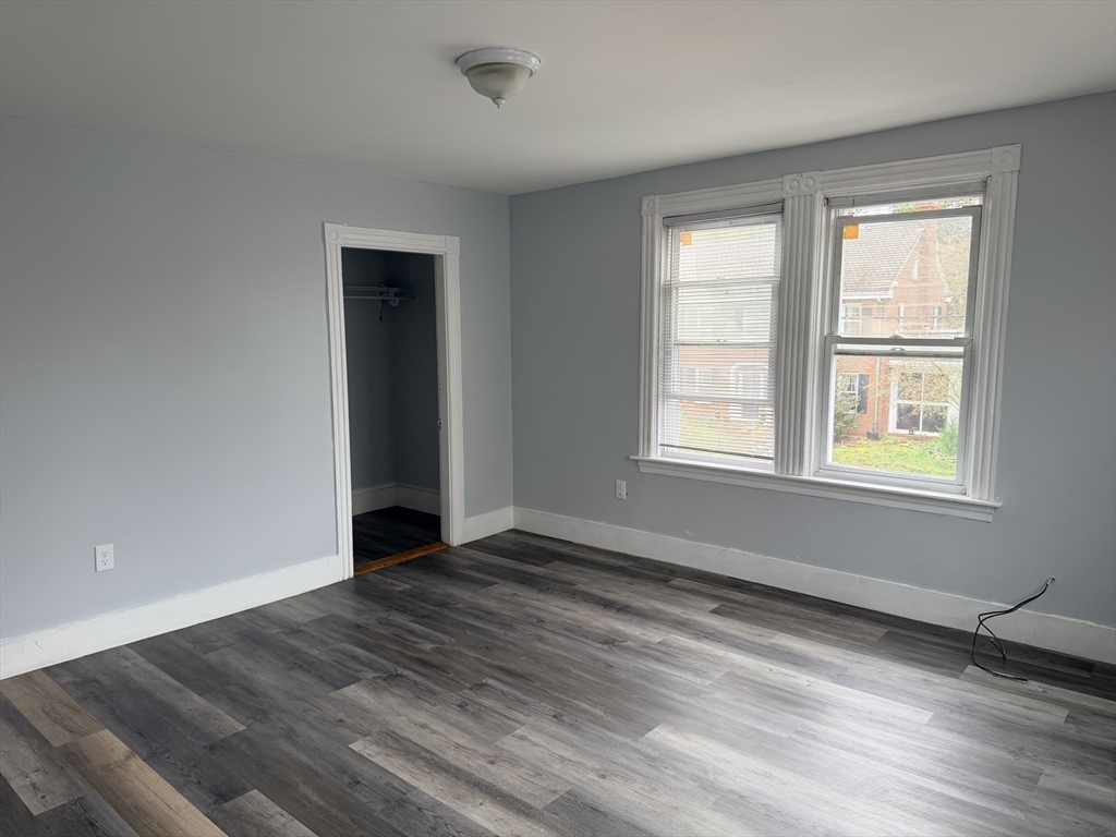 15 Mechanic Street, Unit 2 Attleboro, MA 02703 - Photo 4 of 15 an empty room with wooden floor and windows