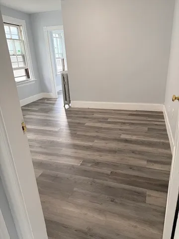 a view of wooden floor and windows in a room