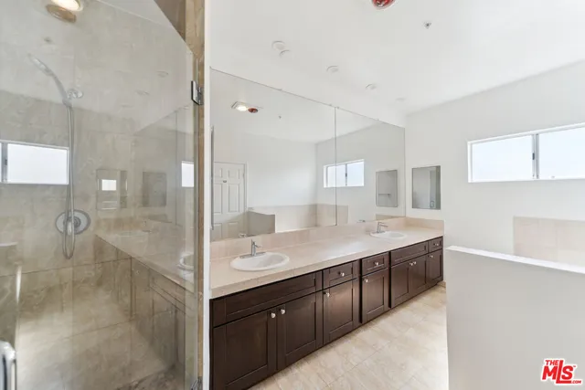 a bathroom with a granite countertop sink mirror and double