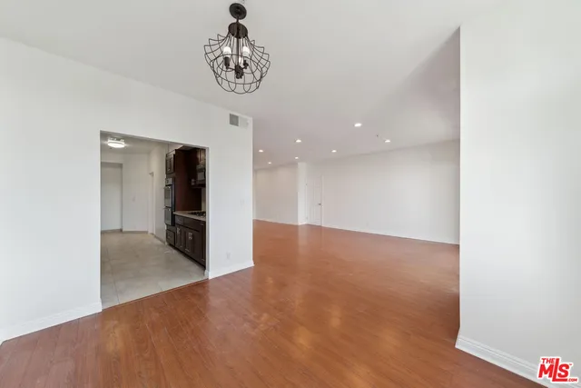 a view of a hallway with a kitchen